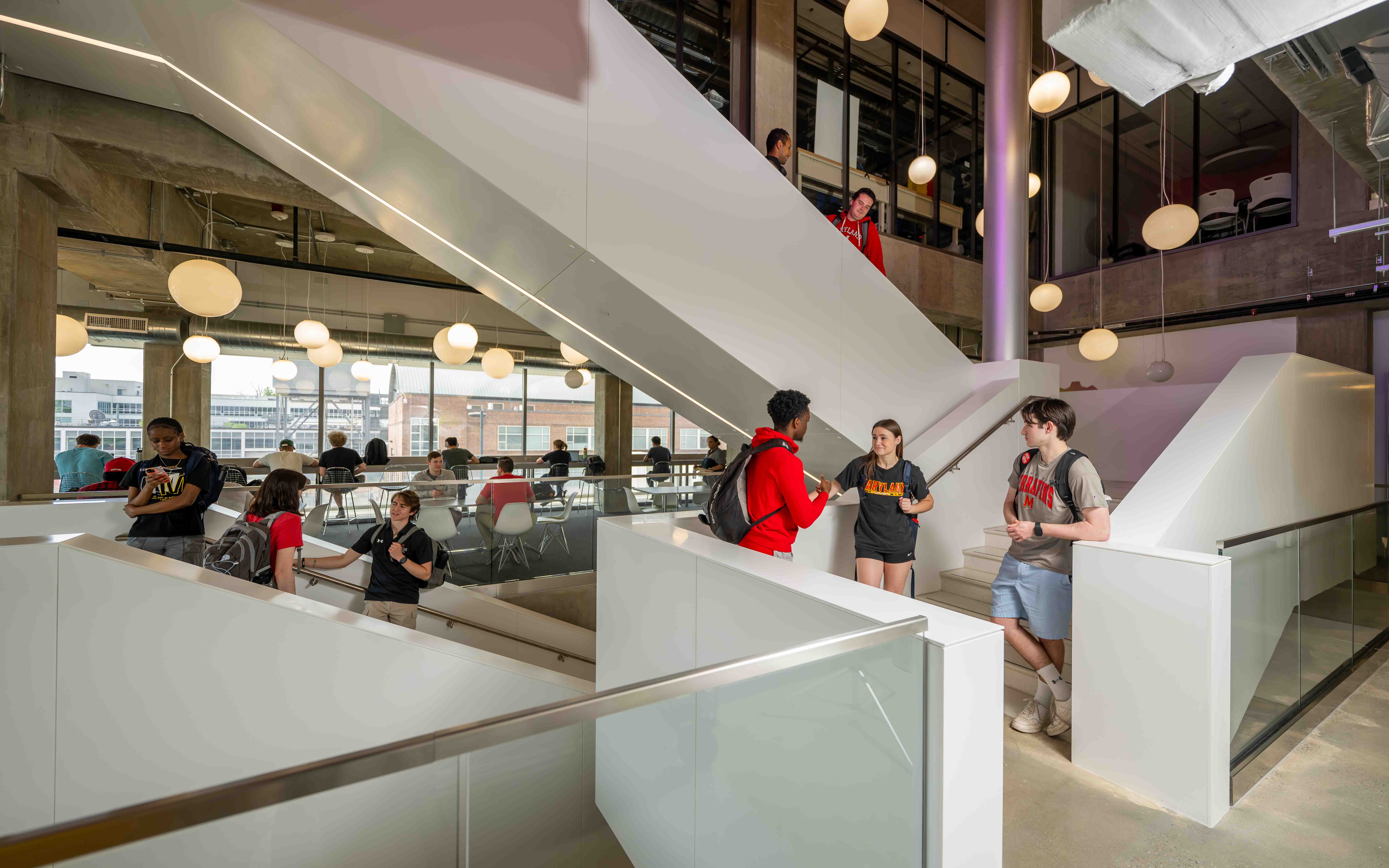 Students walking down the stairs of a building.
