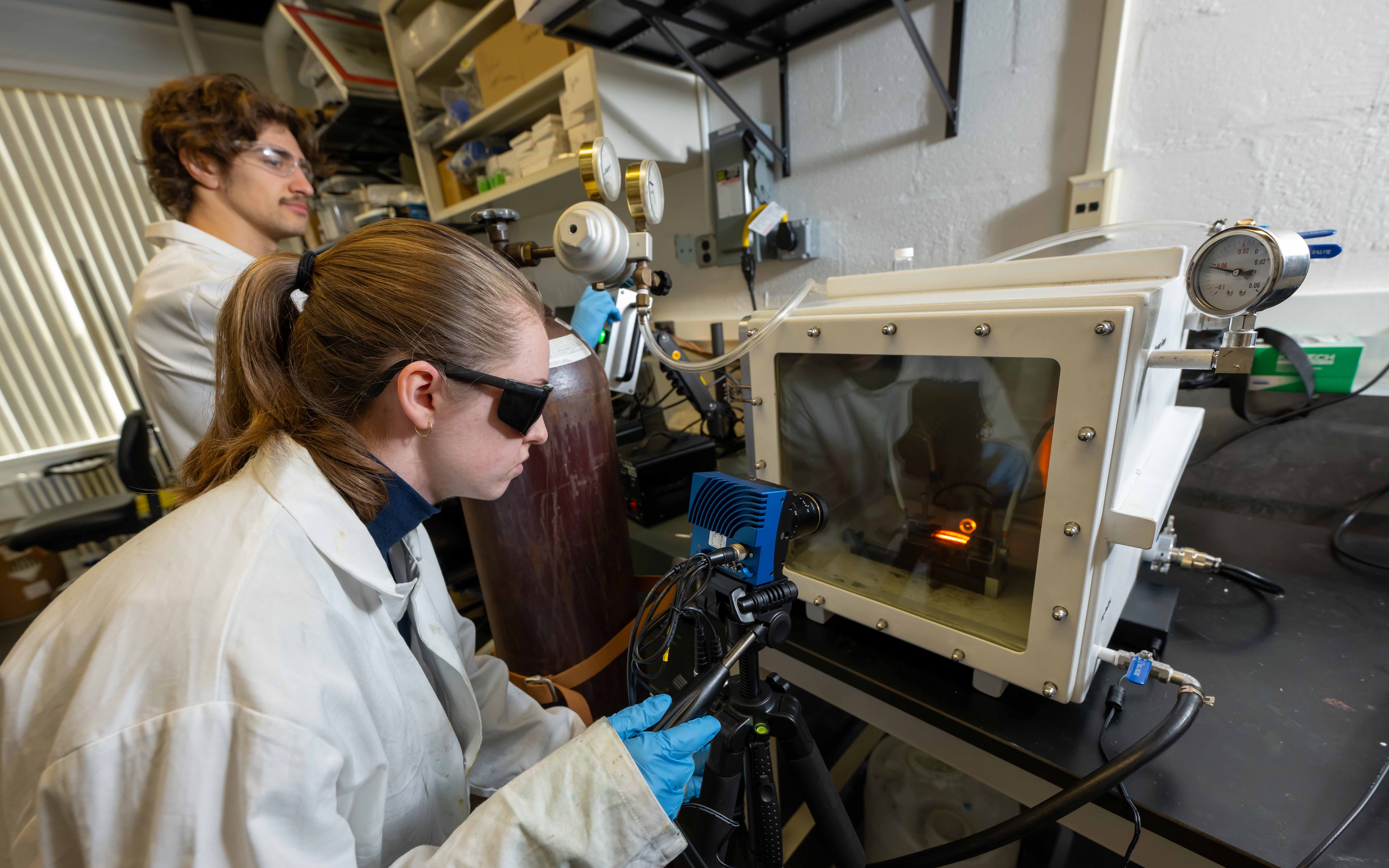 Two students working in the extreme materials laboratory.