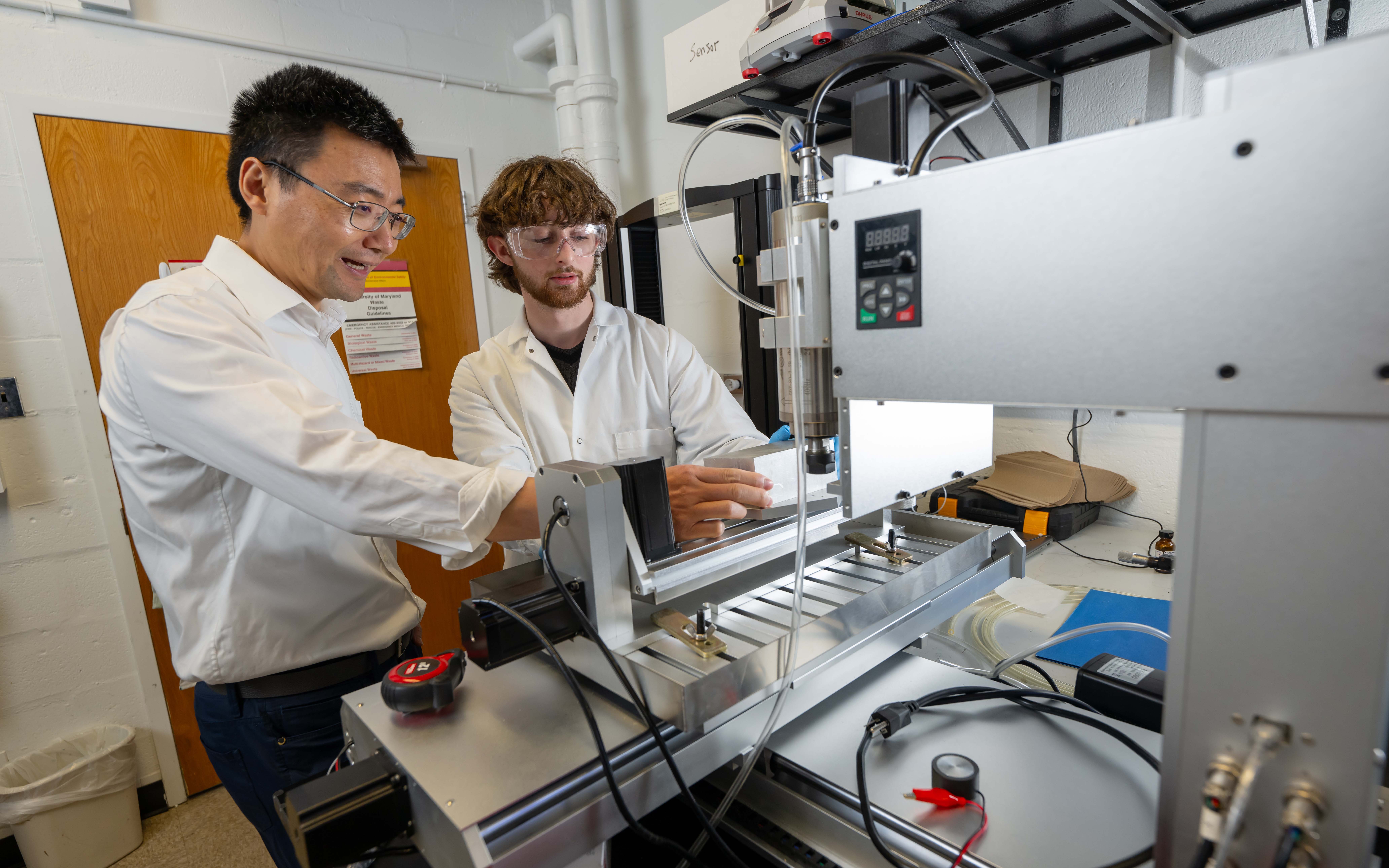 Faculty teaching a student inside a lab.