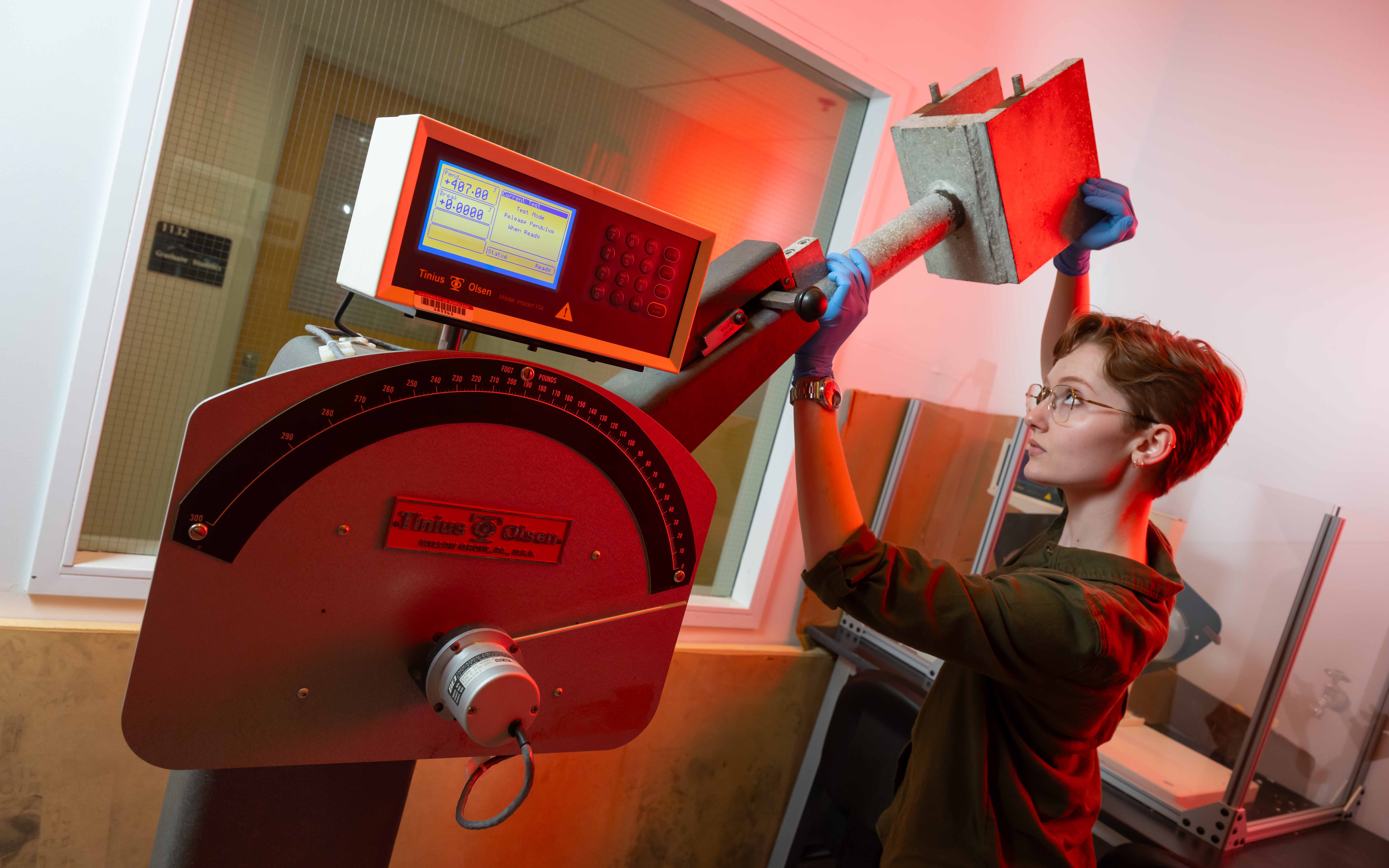 Student operating impact testing hammer.
