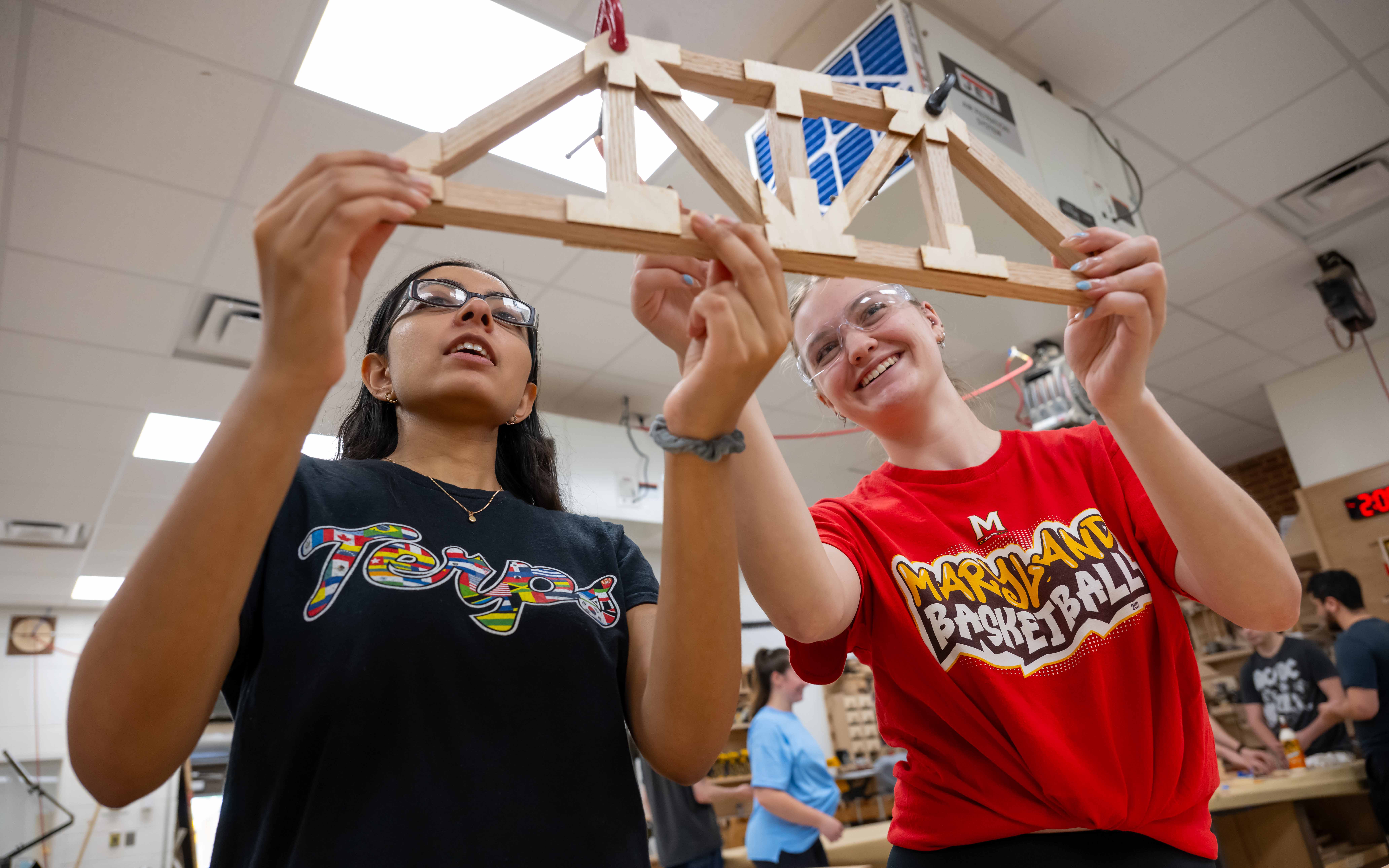 Two students showing wood prototype.